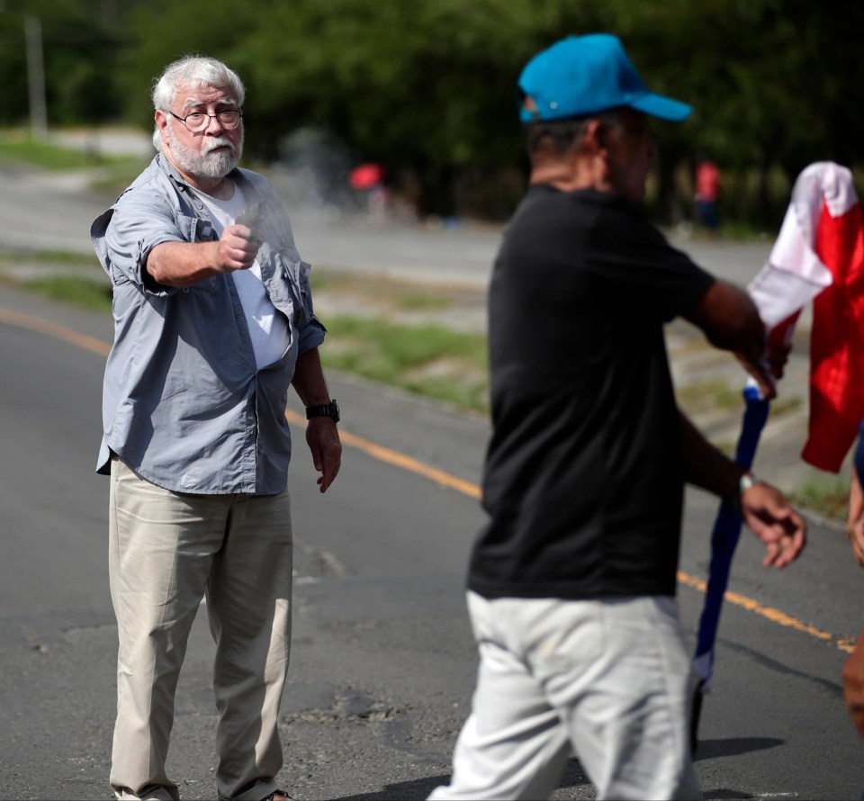 A chilling photo shows Kenneth Darlington opening fire on peaceful protesters