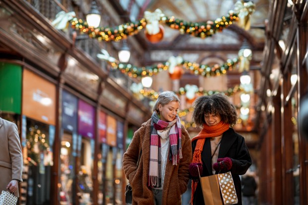 A front view of two women out shopping in Newcastle city centre at Christmas time.