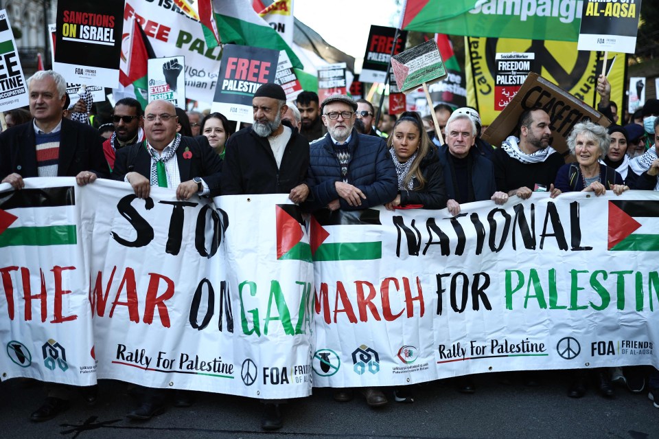 Former Labout party leader Jeremy Corbyn (C) joins protesters with placards and flags taking part in the 'National March For Palestine' in central London on November 11, 2023, calling for a ceasefire in the conflict between Israel and Hamas. Britain's Prime Minister Rishi Sunak has described a planned march in London on Saturday -- Armistice Day, when Britain honours its war dead -- as "provocative and disrespectful" and suggested London's Metropolitan Police ban it. Police have said the march in support of Palestinians does not meet the legal threshold for requesting a government order to stop it going ahead. (Photo by HENRY NICHOLLS / AFP) (Photo by HENRY NICHOLLS/AFP via Getty Images)