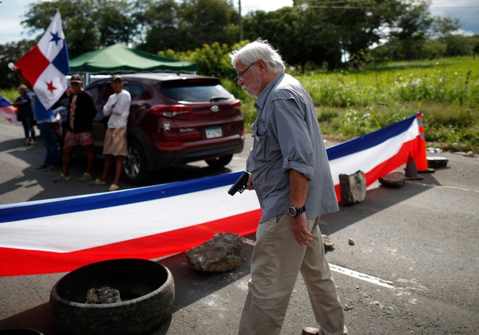 The gunman was seen calmly walking along the road wielding a weapon