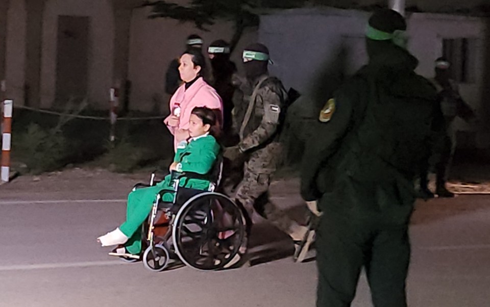 Hostages have been seen in wheelchairs and with bandages on as they're taken by to the Red Cross