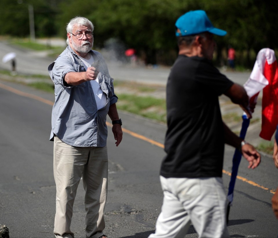 The chilling moment the elderly gunman opened fire on peaceful demonstarters