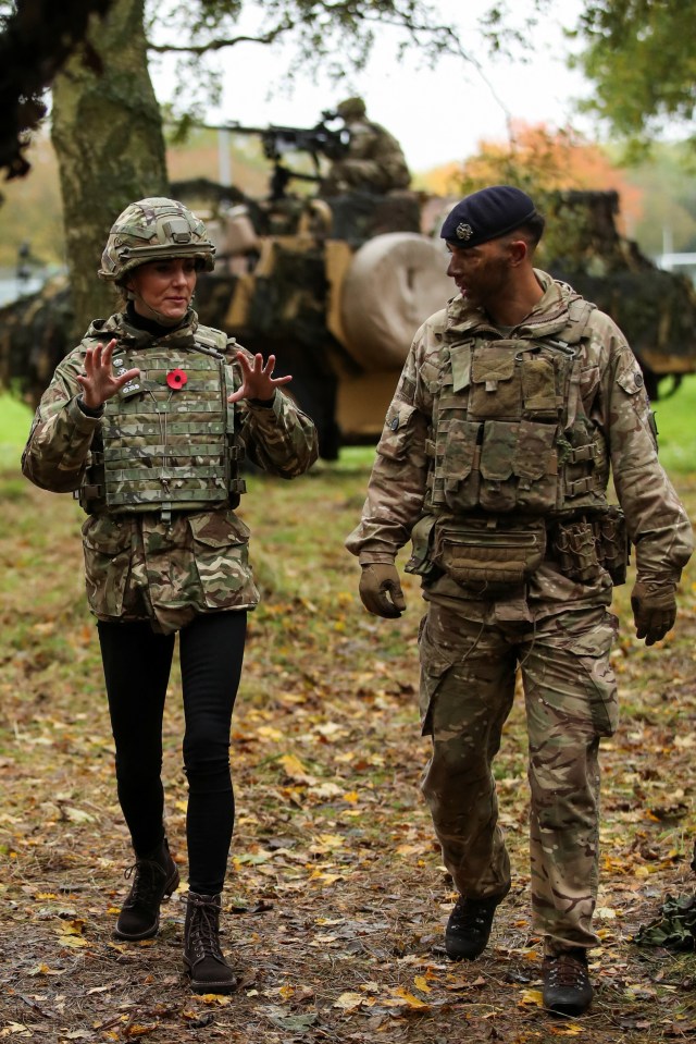 The Princess of Wales gestures as she dons full camouflage gear and a helmet