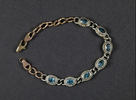 A striking blue and silver bracelet found close to her body