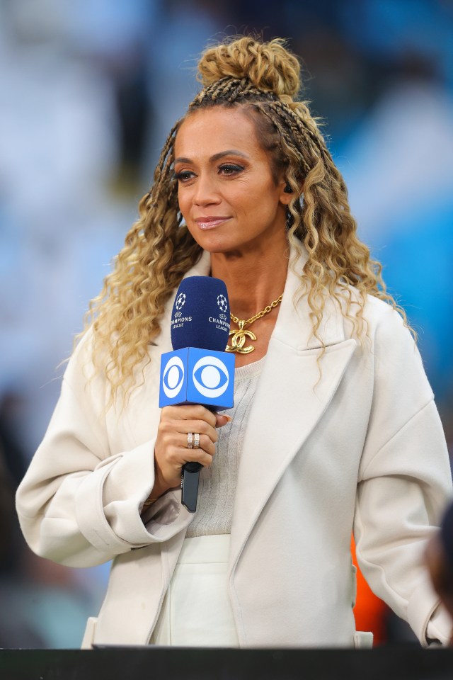 a woman holding a microphone that says champions league on it