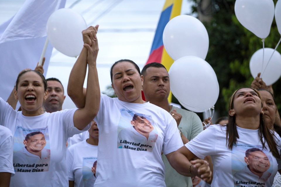 Diaz's mum Cilenis Marulanda, center, takes part in a march