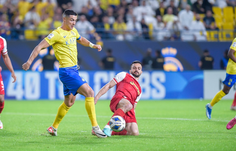 Cristiano Ronaldo went down under a challenge from a Persepolis defender