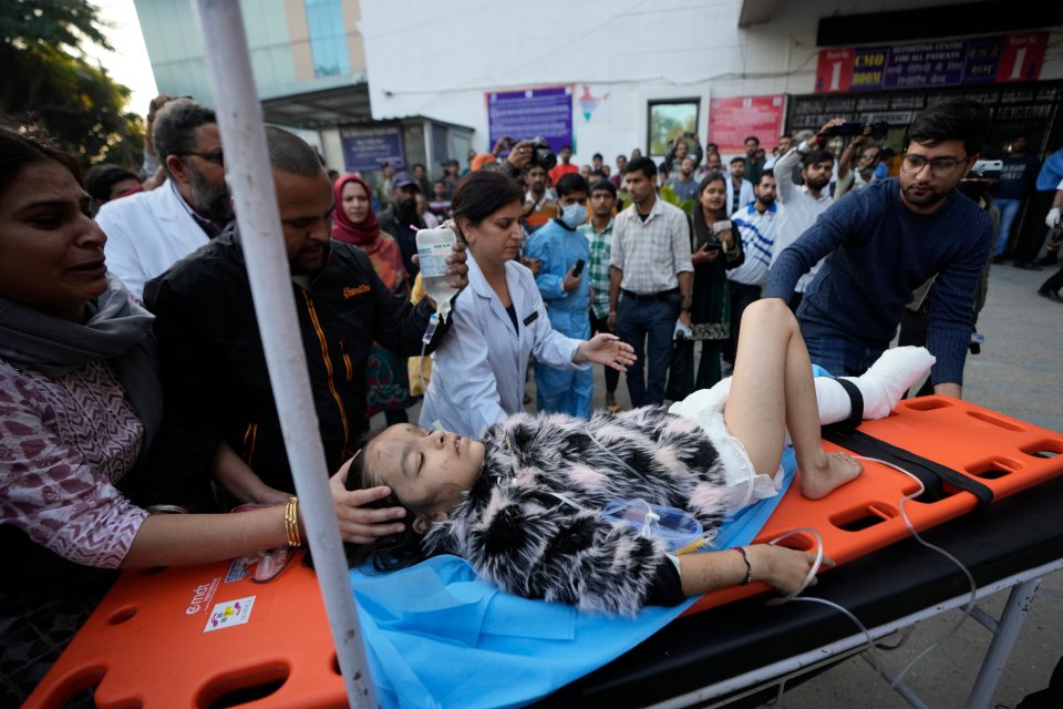 A young girl being taken into hospital