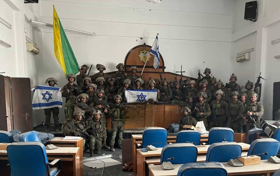 IDF troops appear to be waving flags proudly inside Hamas's government building