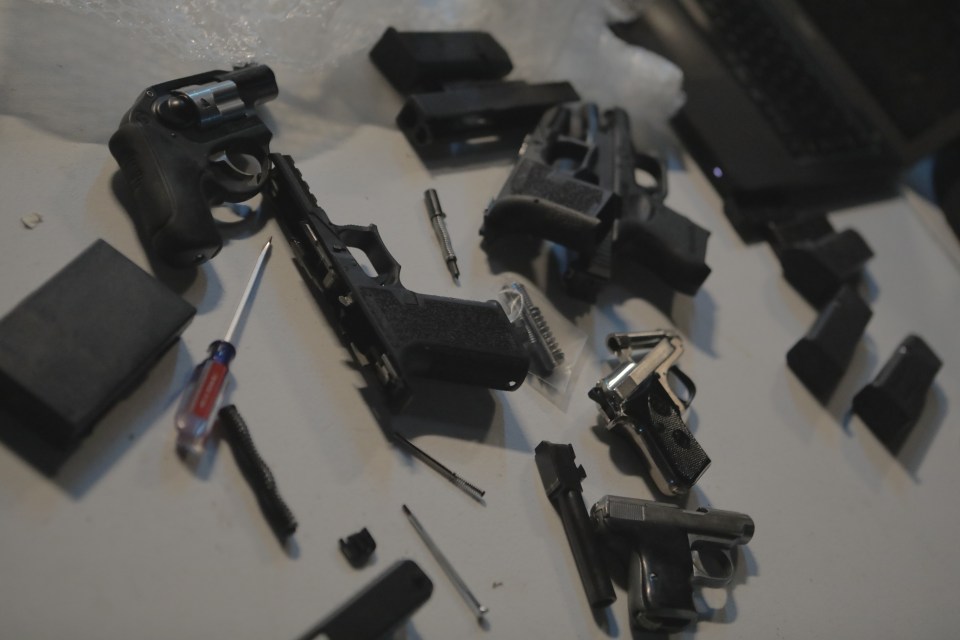 3D printed pistols and parts on a table