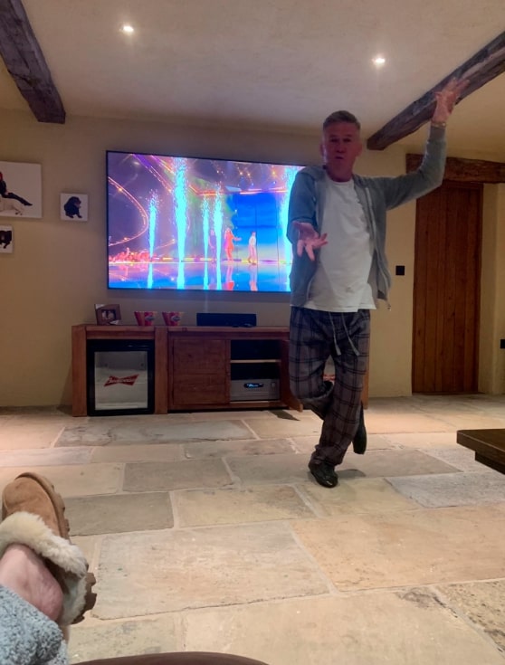 There are exposed beams in the living room and a beer fridge