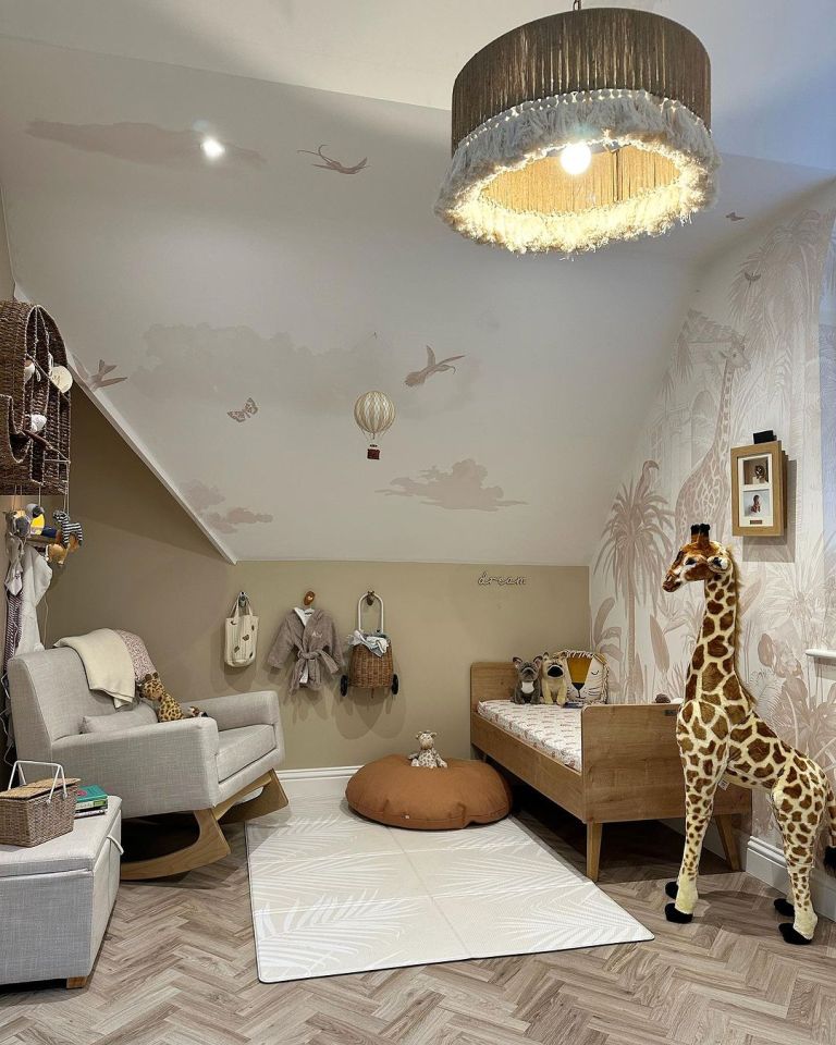 A host of cuddly toys fill the space including a huge giraffe