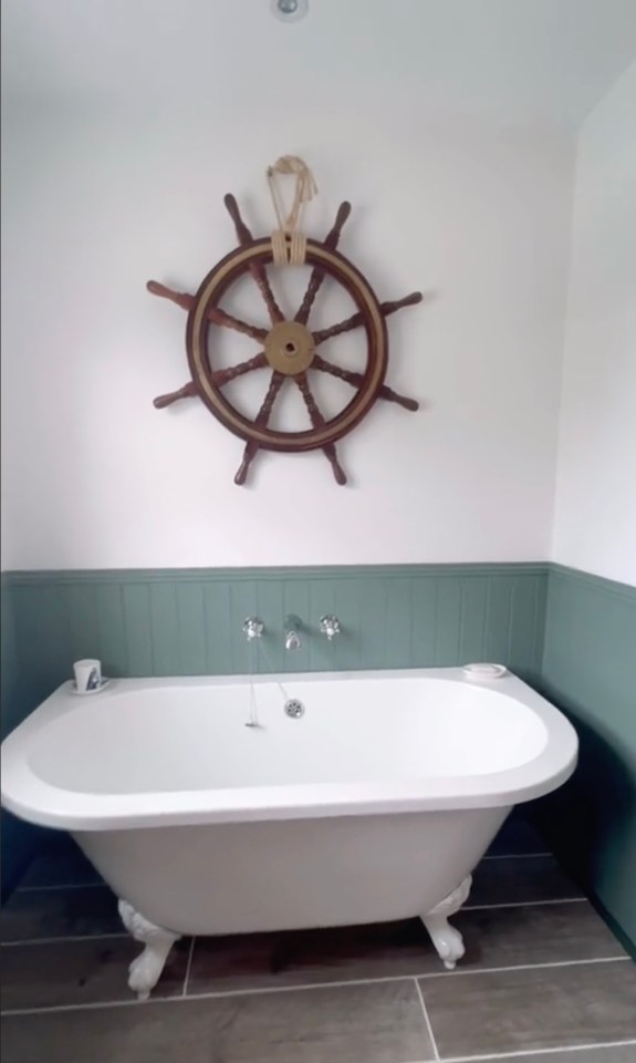 The bathroom features a ship's wheel in a nod to Cornwall's coastal geography