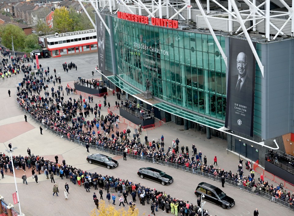 The funeral cortege making its way past the United Trinity statue outside Old Trafford