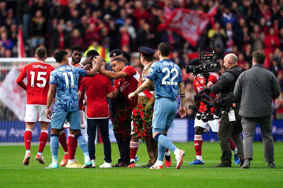 Nottingham Forest and Aston Villa players consoled the young fan on the trumpet after he lost his way performing The Last Post