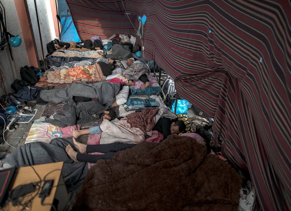 Displaced Palestinians take refuge inside a hospital inside southern Gaza