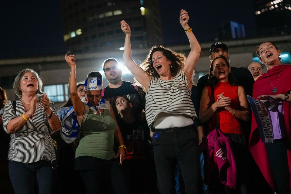 People celebrate as they hear the news that 13 Israeli hostages have been released by Hamas