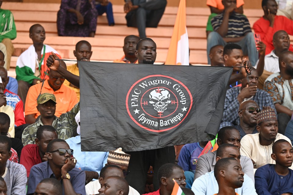 A man carries the haunting black insignia of the Kremlin-backed Wagner Group in Niger