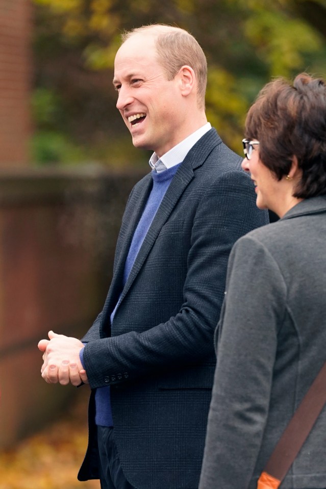 Prince William has been seen grinning this morning on a visit in Manchester