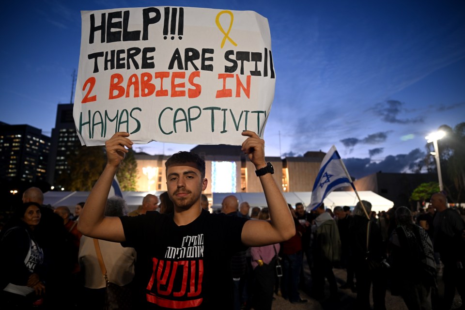 Protesters hold up signs calling for the release of the children