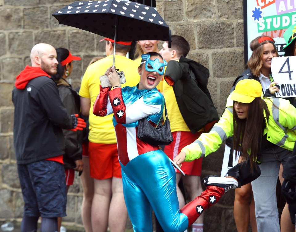 The rain didn't dampen one girl's spirits - as she showed off her superhero outfit in Leeds