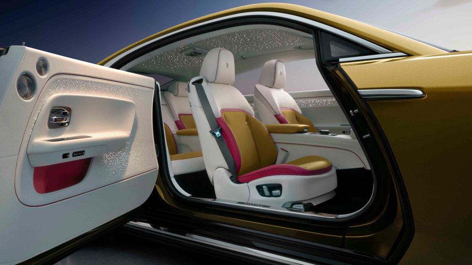 The interior uses high-quality materials such as leather and wood