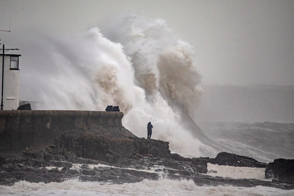 A monster wave hits Porthcawl Lighthouse in Wales on Sunday