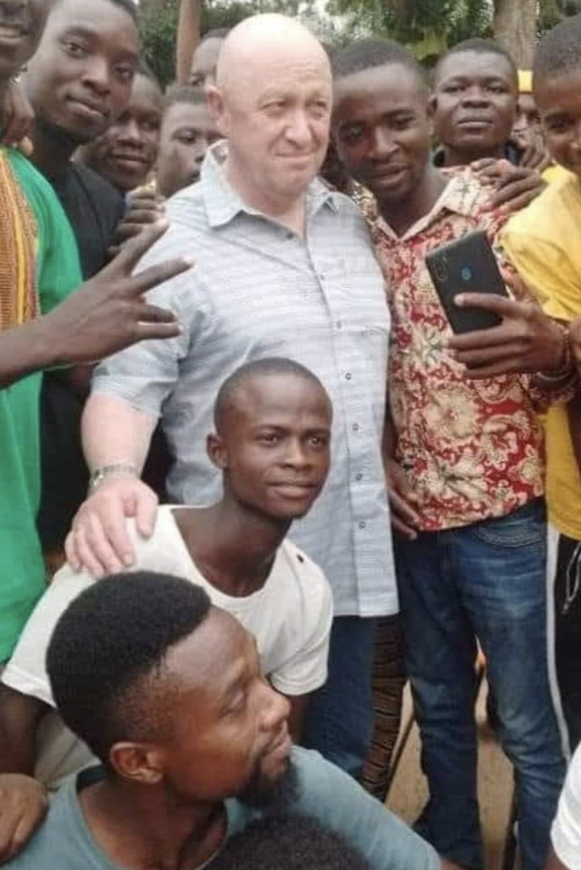 An undated picture of Prigozhin in an African nation surrounded by local supporters