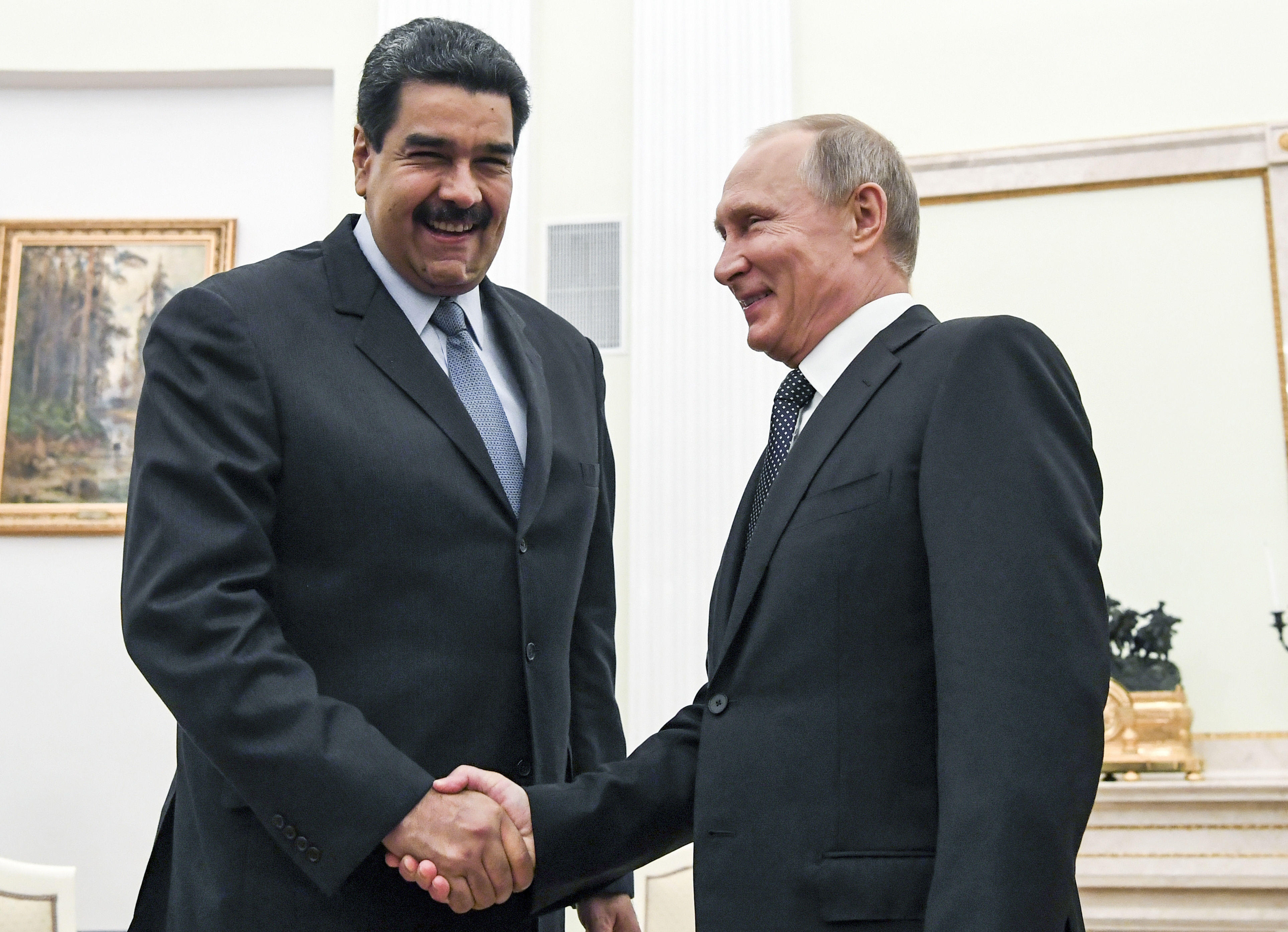 Putin, right, shakes hands with Maduro during their meeting at the Kremlin in Moscow in 2017