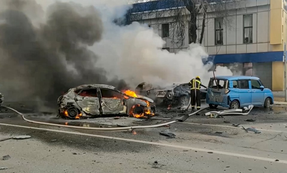 Russian firefighters battle to extinguish burning cars in Belgorod after the Ukrainian attack that killed at least 24