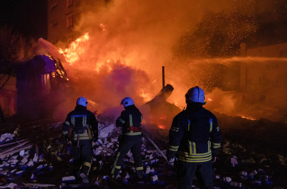 Ukrainian rescuers battle a blaze following a Russian drone attack on downtown Kharkiv early this morning