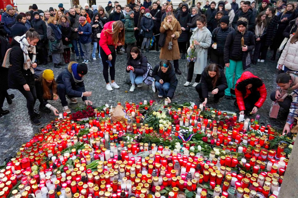 Mourners lay candle lights outside Charles University today