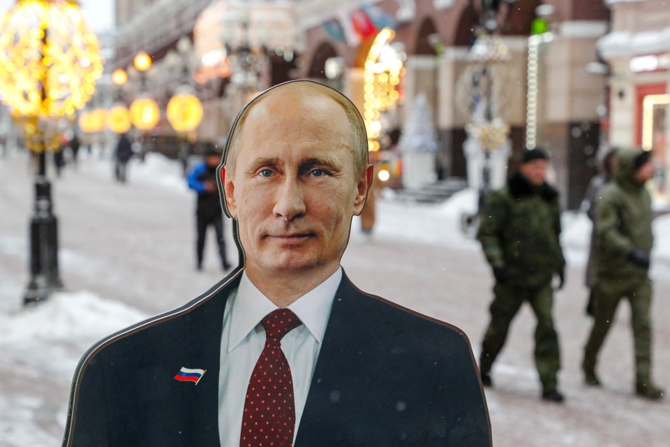 A cardboard cutout of Russian President Vladimir Putin stands on a street near a souvenir shop before the press confernece