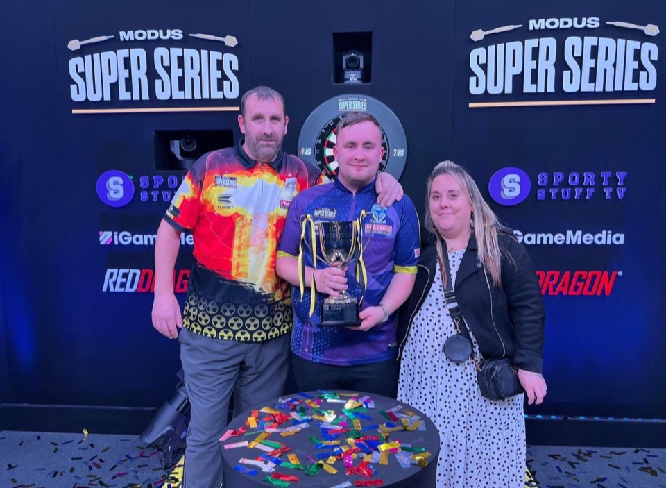 Luke, with proud parents Anthony and Lisa, as he lifts another trophy