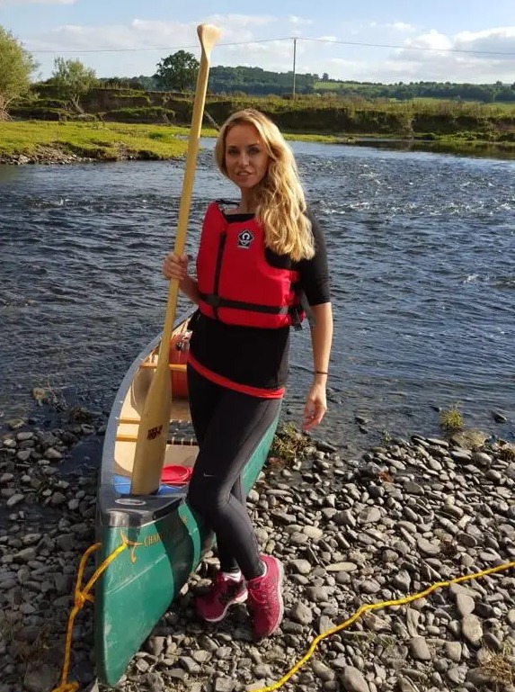 Josie holds an oar on a day out