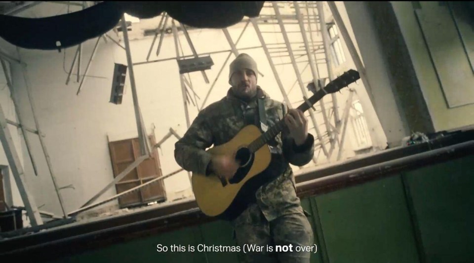 Sashko Remiz is filmed playing guitar as he sings 'the war is not over'