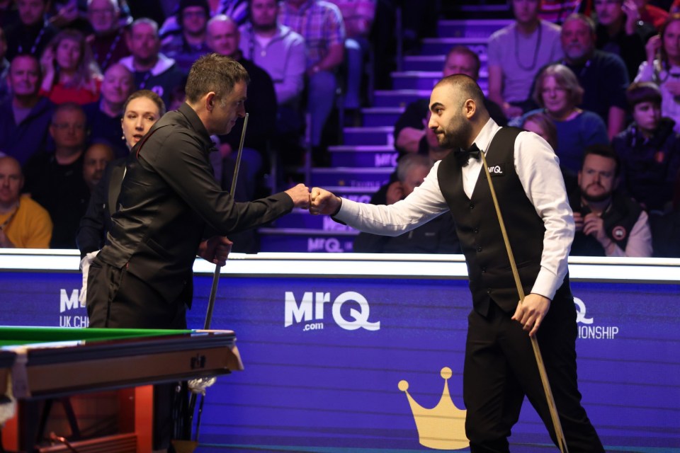 YORK, ENGLAND - DECEMBER 02: Ronnie O'Sullivan of England interacts with Hossein Vafaei (R)of Iran prior to their Semi Final match on Day Eight of the MrQ UK Snooker Championship 2023 at York Barbican on December 02, 2023 in York, England. (Photo by George Wood/Getty Images)