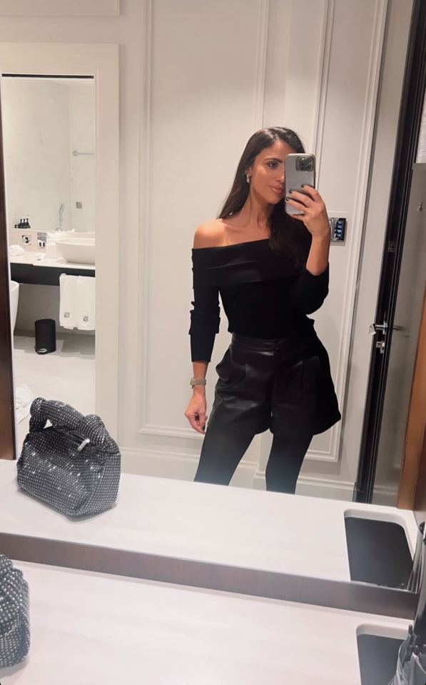 Lucy looked stunning in a off-the-shoulder black top and black leather shorts