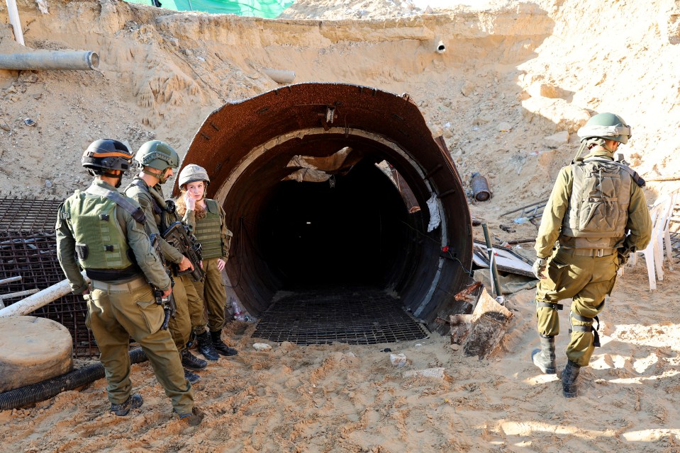 In this picture taken during a media tour organised by the Israeli military on December 15, 2023, soldiers stand at the entrance of a tunnel that Hamas reportedly used to attack Israel through the Erez border crossing on October 7. The Israeli army said on December 17, 2023 it had uncovered the biggest Hamas tunnel in the Gaza Strip so far, just a few hundred metres from the Erez border crossing. (Photo by JACK GUEZ / AFP) (Photo by JACK GUEZ/AFP via Getty Images)