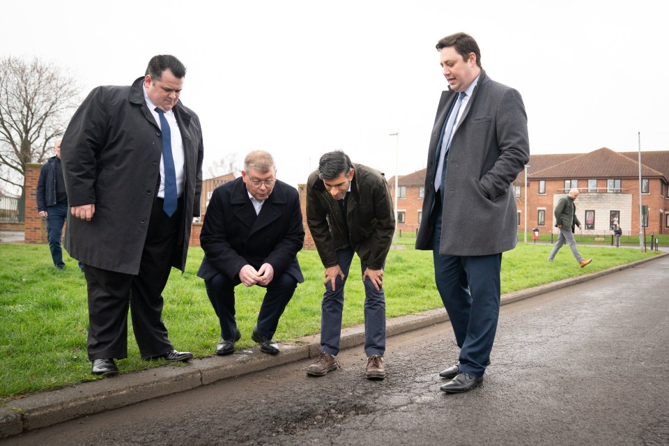 Prime Minister Rishi Sunak with Darlington Council leader Jonathan Dulston (far left), Tees Valley Mayor Ben Houchen (far right) and Darlington MP Peter Gibson (second from left) in Firth Moor looking at a pothole during a visit to Darlington, County Durham, as potholes take more than 18 months to be fixed in some areas, the Liberal Democrats claimed as the party blamed a "postcode lottery" in its latest attack on Tory spending cuts. PA Photo. Issue date: Monday April 17, 2023. Repairs took up to 567 days in Stoke-on-Trent and up to 556 days in the Westminster Council area, according to data obtained by the party through freedom of information requests. See PA story POLITICS Potholes. Photo credit should read: Stefan Rousseau/PA Wire