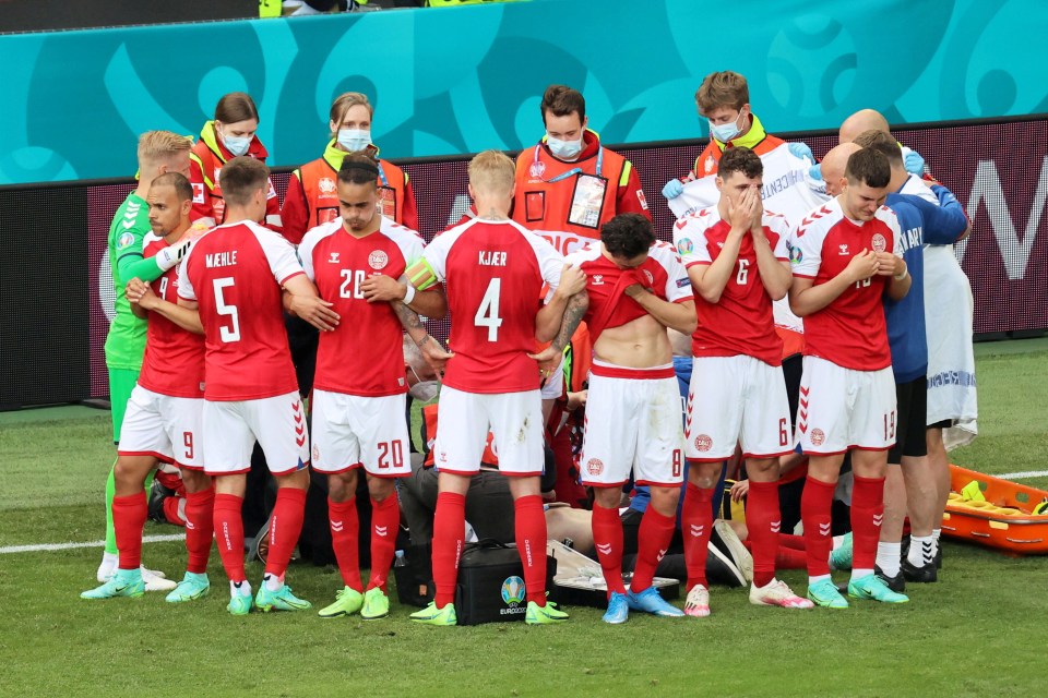 Denmark players form a circle around Christian Eriksen as medics battle to save him