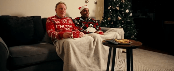 Warnock is seen snuggling next to Clinton Morrison in the advert