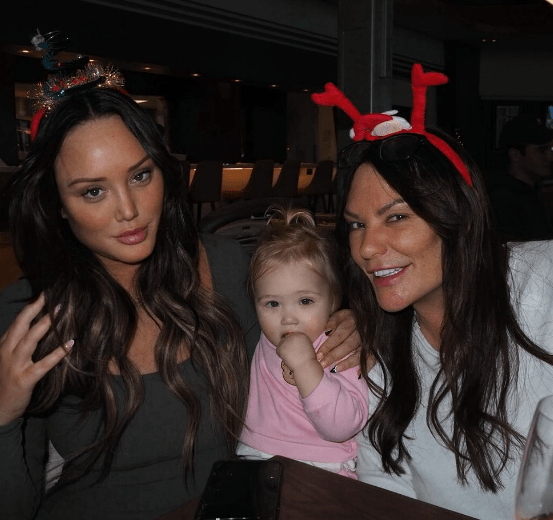 Charlotte cuddled up with her daughter and mum at the airport