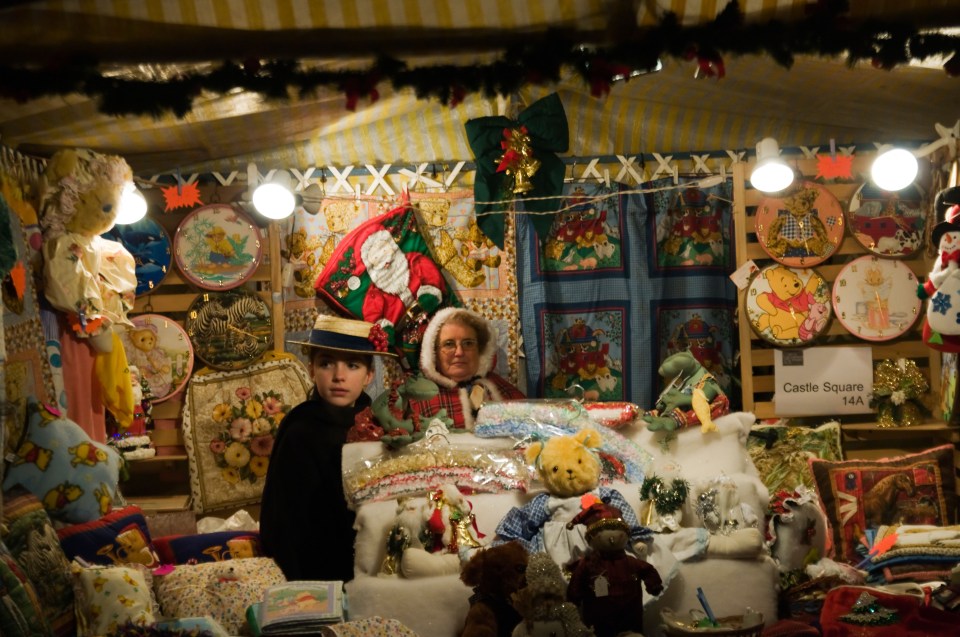 Two women standing behind a Christmas market stall