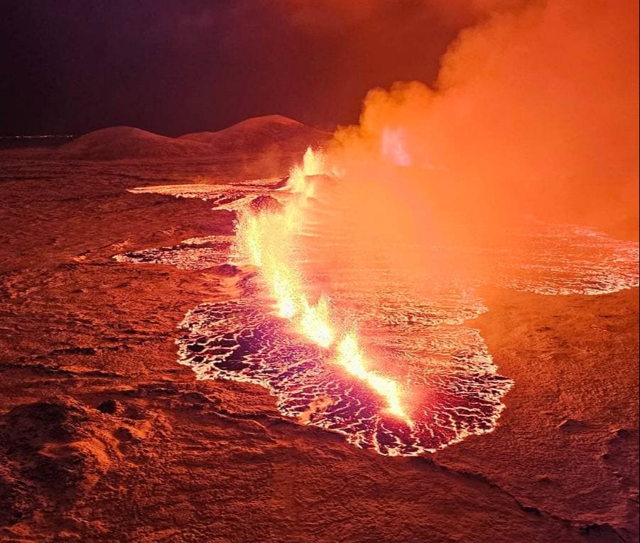 Billowing smoke and flowing lava turning the sky orange are seen in this Icelandic Department of Civil Protection and Emergency Management handout image during an volcanic eruption on the Reykjanes peninsula 3 km north of Grindavik, western Iceland on December 19, 2023. A volcanic eruption began on Monday night in Iceland, south of the capital Reykjavik, following an earthquake swarm, Iceland's Meteorological Office reported. (Photo by Icelandic Department of Civil Protection and Emergency Management / HANDOUT / AFP) / RESTRICTED TO EDITORIAL USE - MANDATORY CREDIT "AFP PHOTO / " - NO MARKETING NO ADVERTISING CAMPAIGNS - DISTRIBUTED AS A SERVICE TO CLIENTS (Photo by ICELANDIC DEPARTMENT OF CIVIL PROTECTION AND EMERGENCY MANAGEMENT/HANDOUT/AFP via Getty Images)