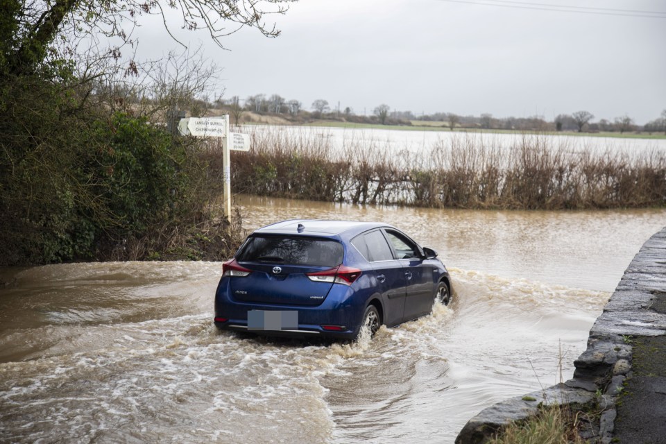 Drivers were forced to make their way through a flooded road in Wiltshire this morning