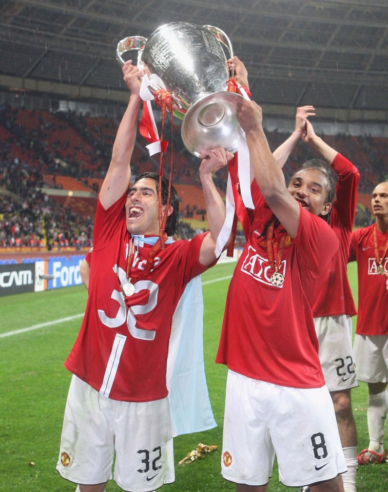 The Brazilian hoists the Champions League trophy with Carlos tevez