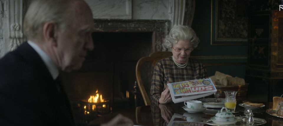 The Queen, played by Imelda Staunton, is seen reading The Sun