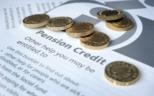 gold coins on top of a pension credit booklet