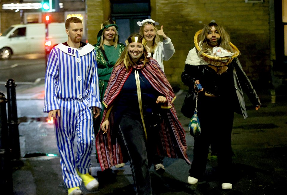 Partiers dressed as baby Jesus, Mary and the Three Wise Men